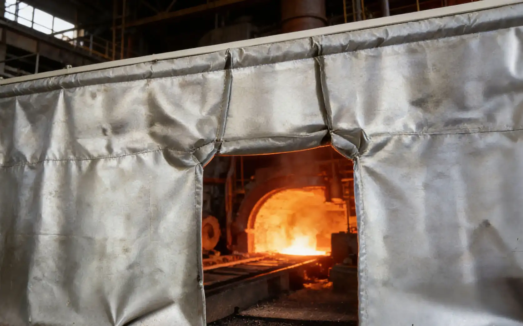Thermal barrier curtain installed in industrial furnace environment